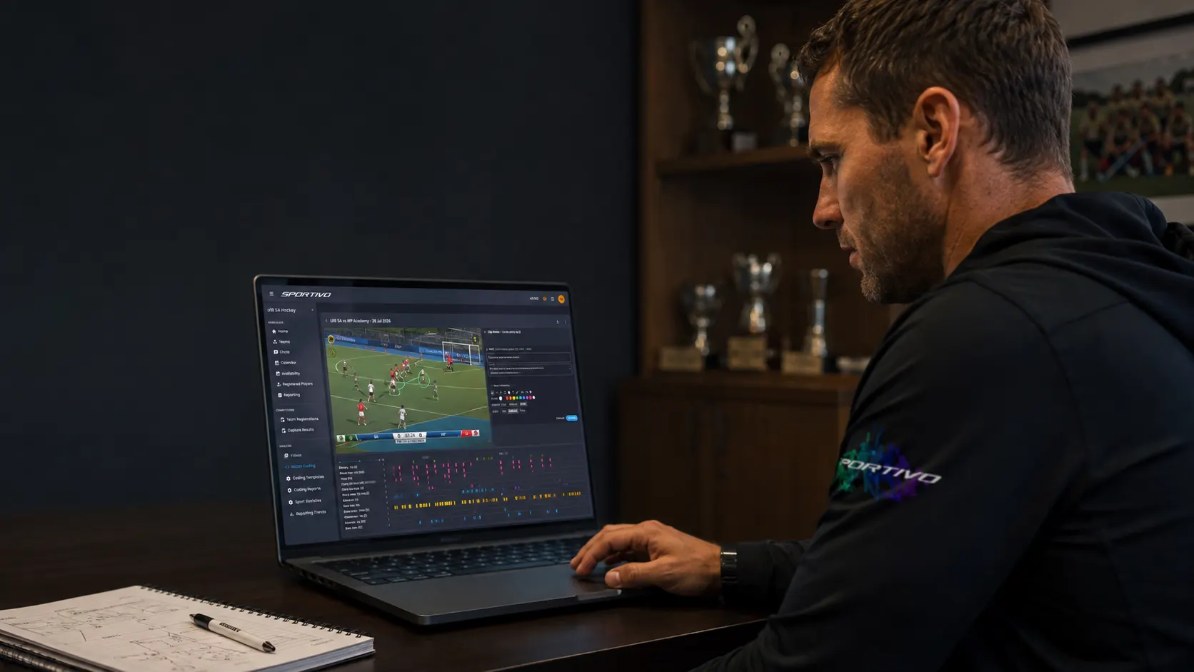 Coach analysing match footage with video coding tools on a laptop
